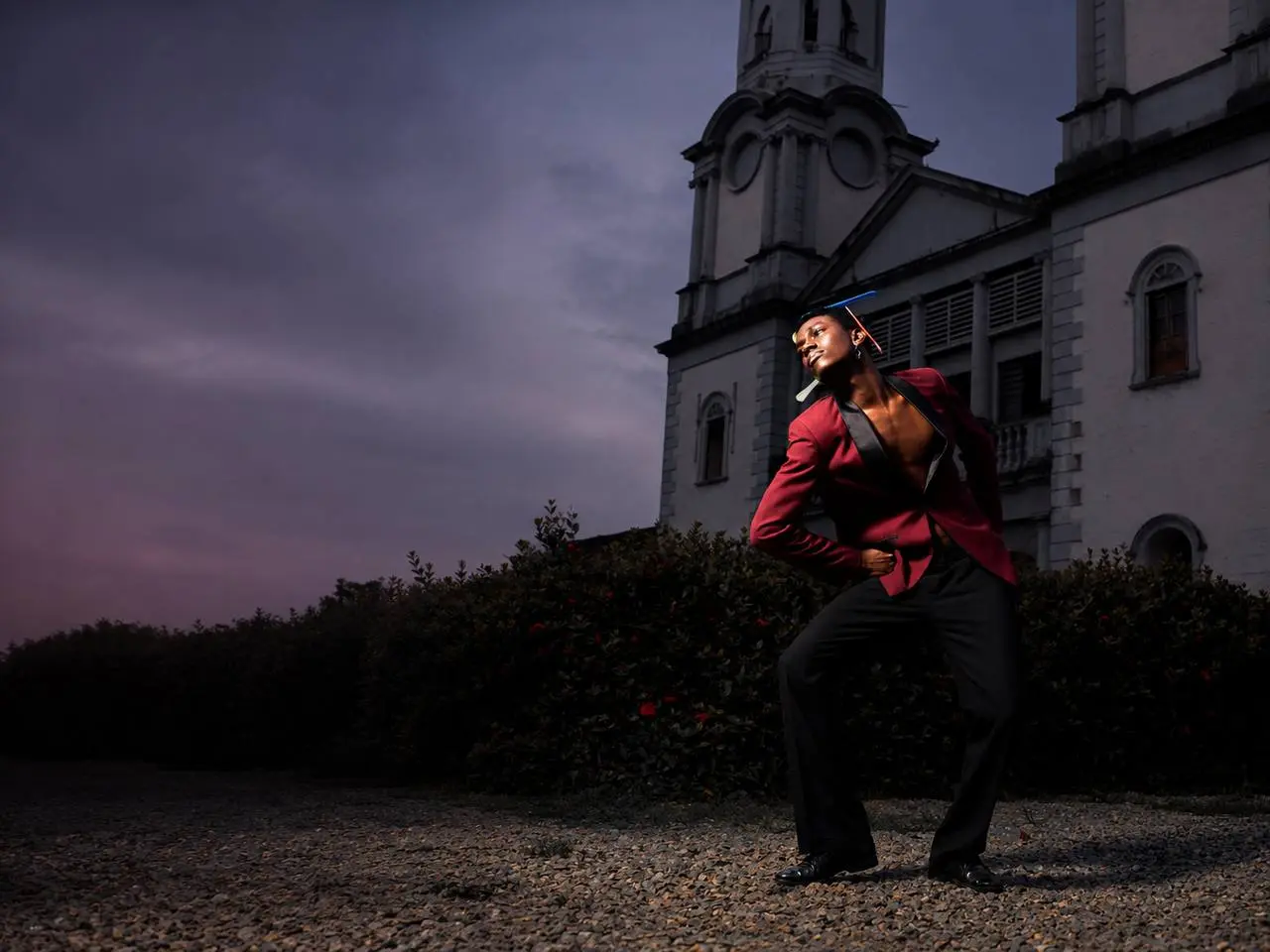 BrightQuests model in a red tailored look on location